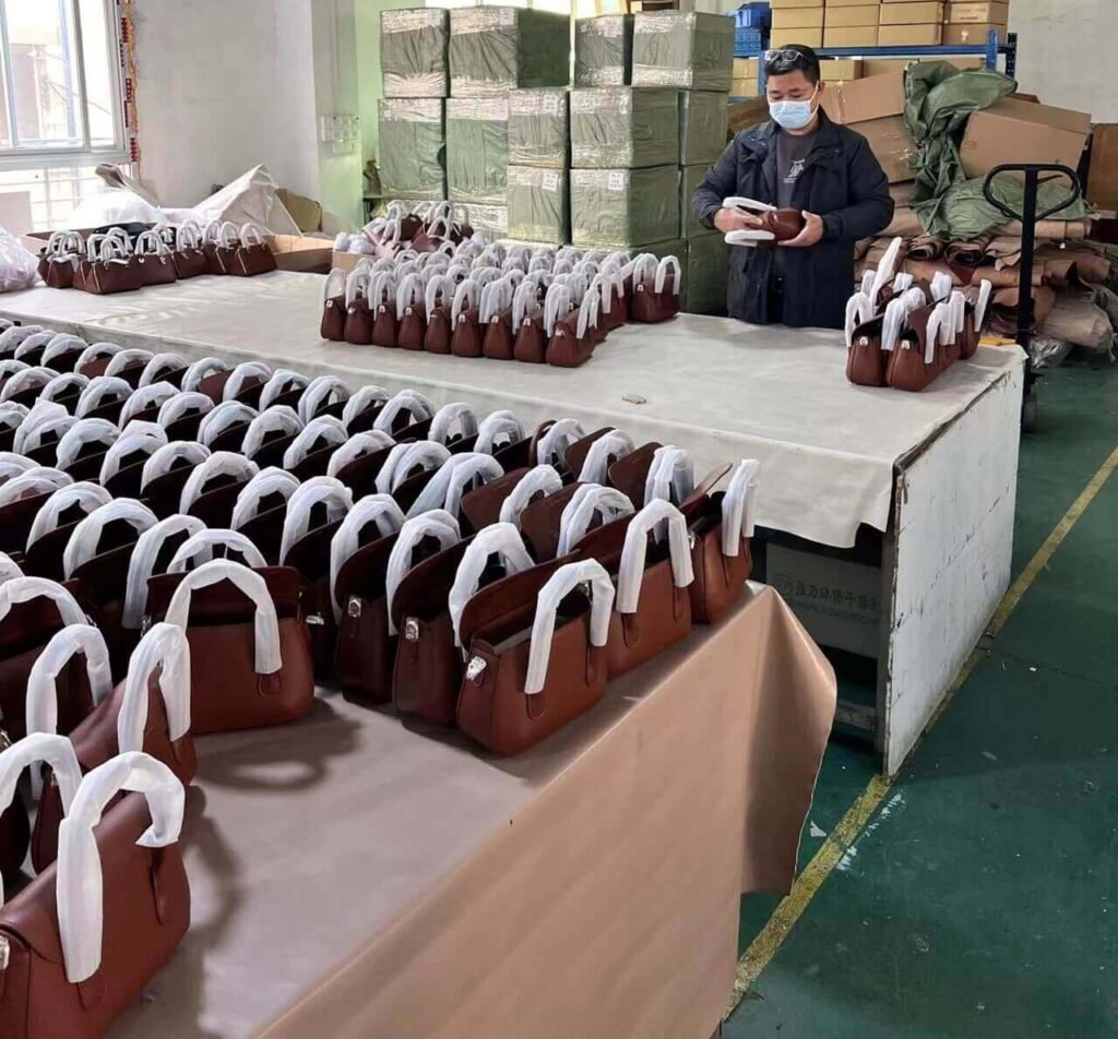 quality control inspection in leather bag manufacturing workshop