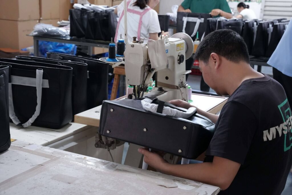 Skilled craftsmen performing precision stitching for custom leather bags at Solton Leather factory