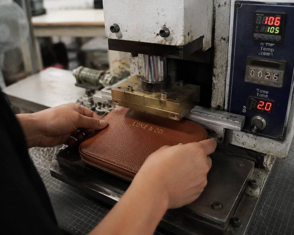 How Custom Makeup Bags Are Made: From Design Concept to Mass Production 5 custom logo embossing on leather makeup bag private label branding factory