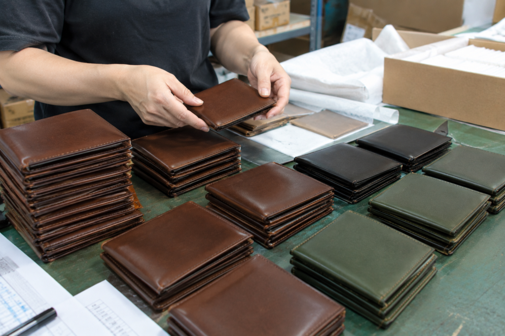 How to Choose a Leather Wallet Manufacturer: A B2B Buyer's Guide 5 Finished leather wallets ready for B2B bulk shipment